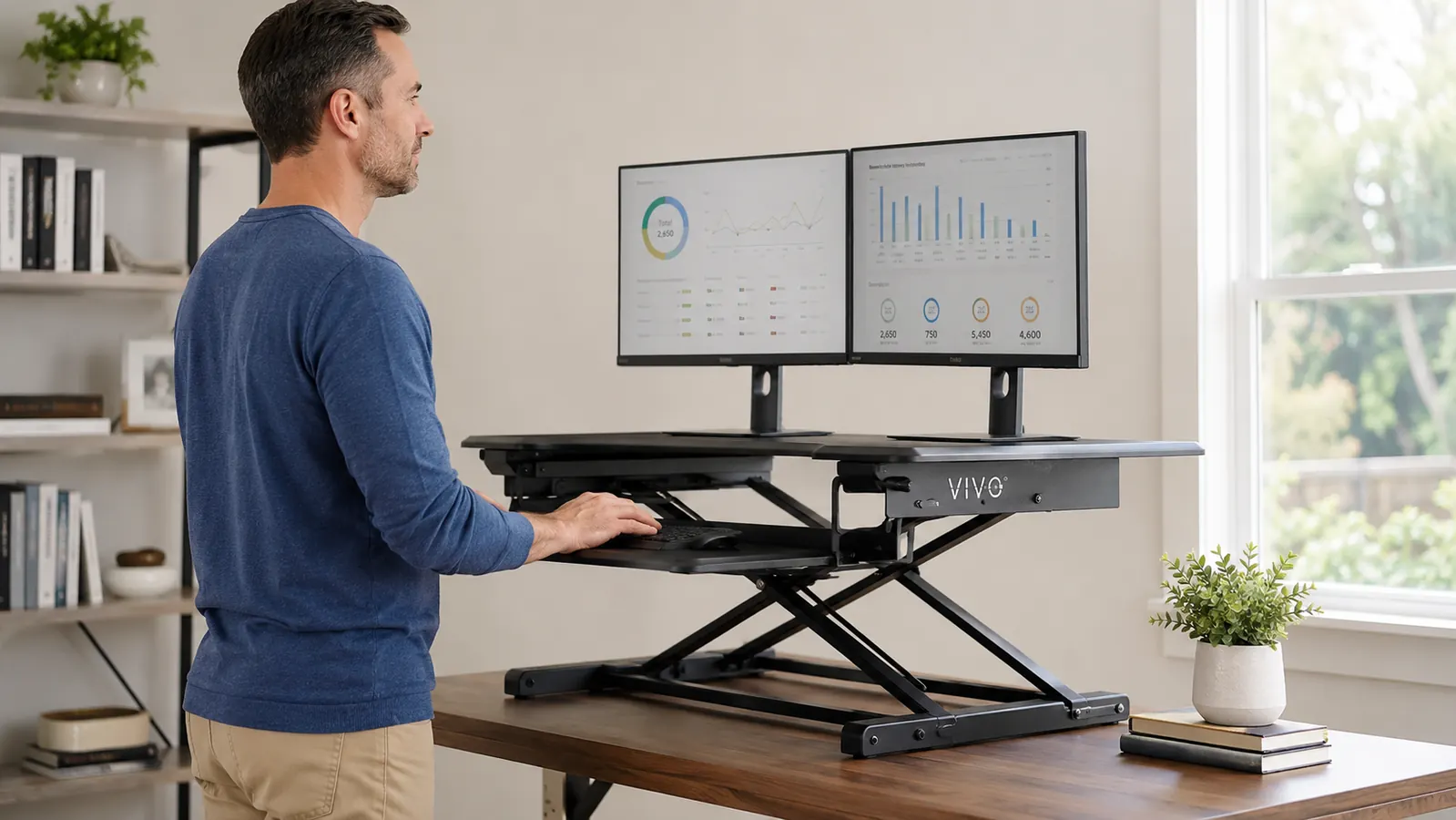 Close-up of a VIVO 32-inch desk converter showing the spring-assist lift mechanism mid-raise