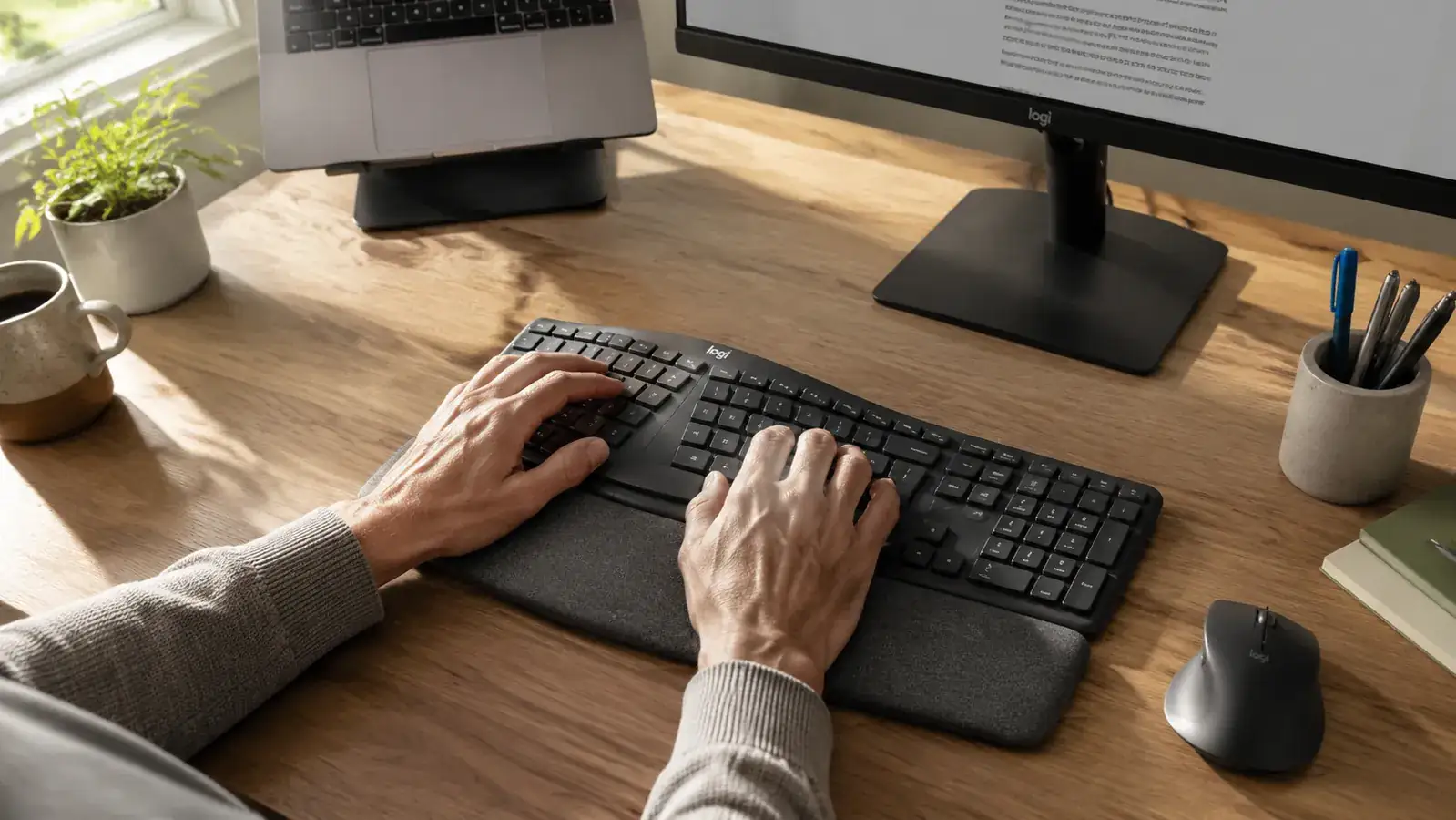 Hands resting on the K860 wrist rest in a natural typing position showing the outward wrist angle