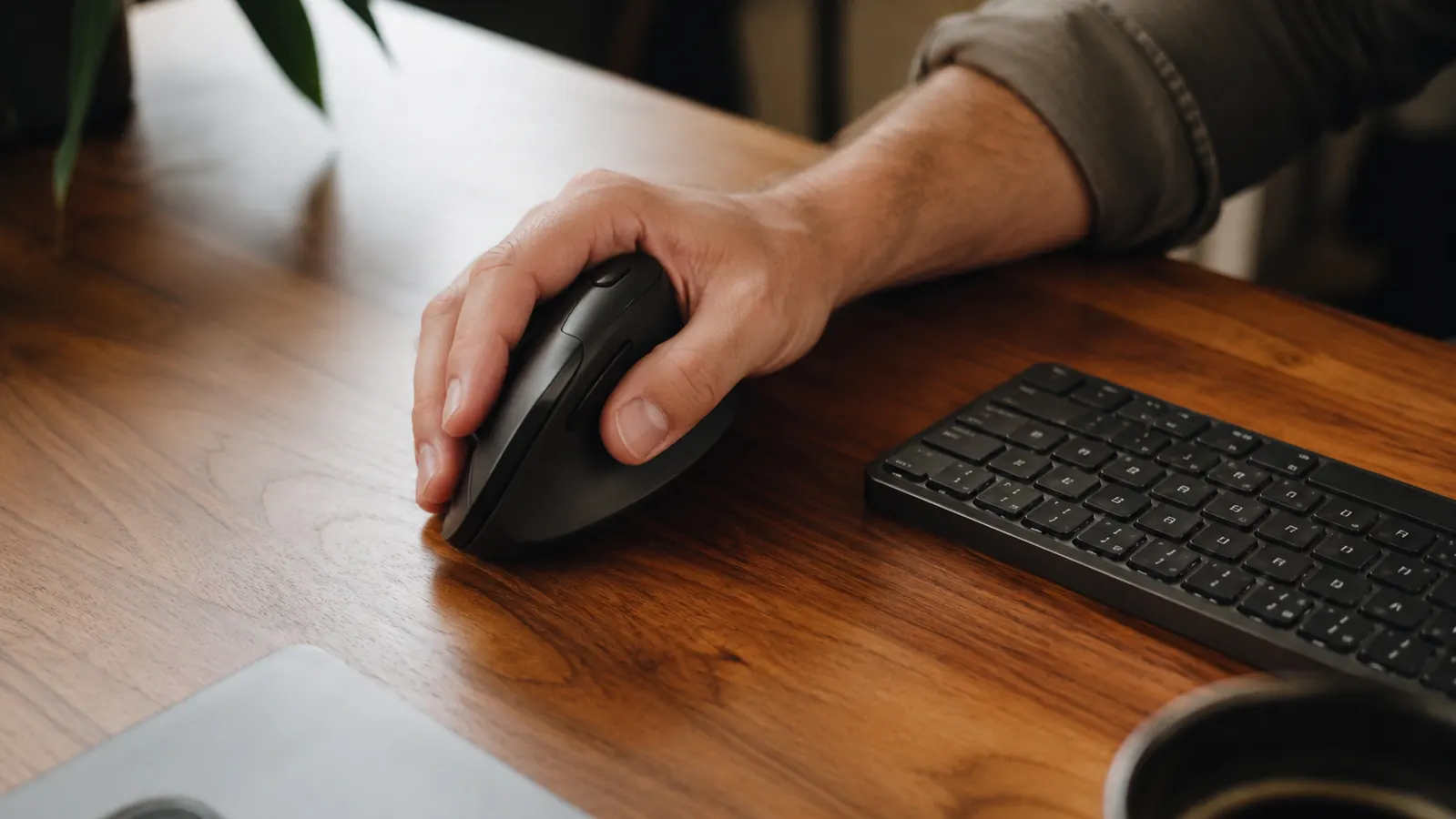 Person working at a standing desk using a vertical mouse during a long remote workday